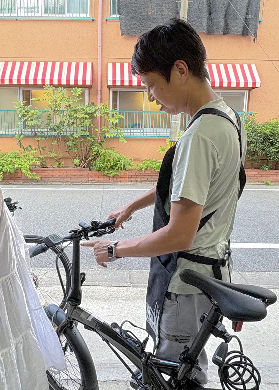 電動自転車VEKTRONの操作方法について説明しているスタッフの写真。